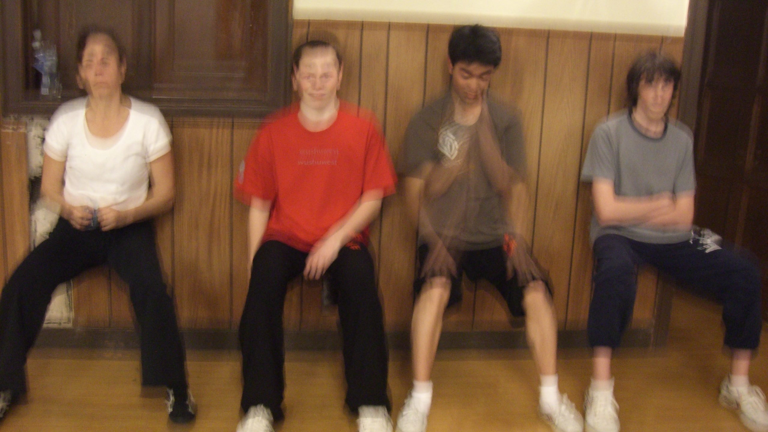 Wushu athletes doing wall sits