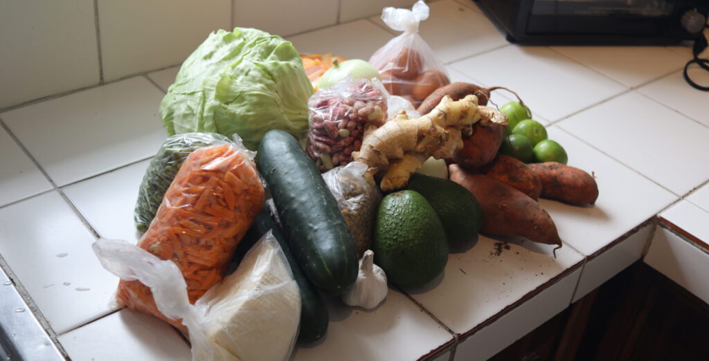 A pile of vegetables and fruit on a countger