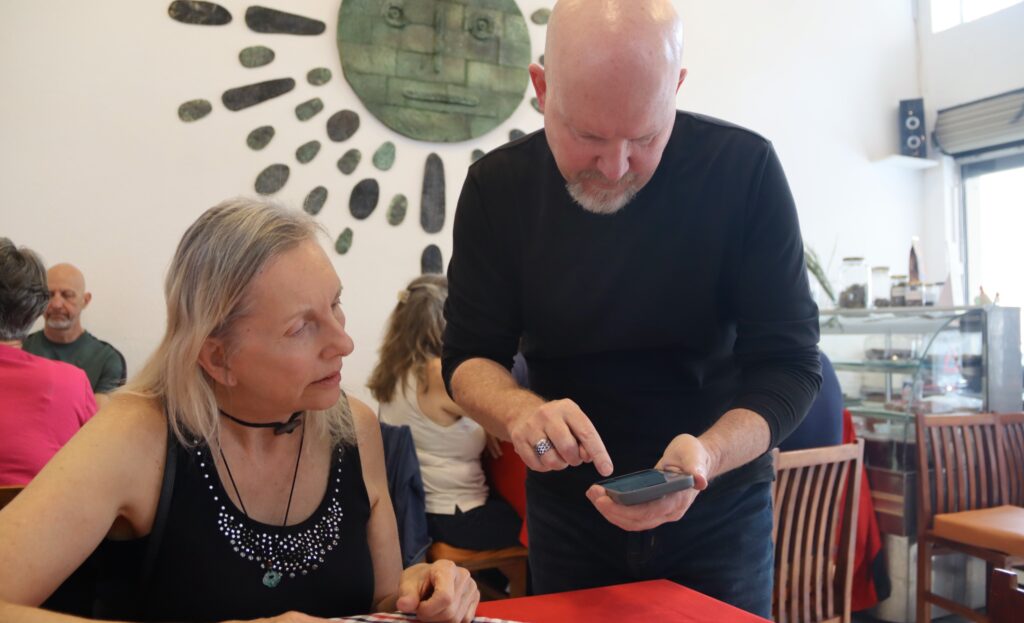 two people looking at a phone