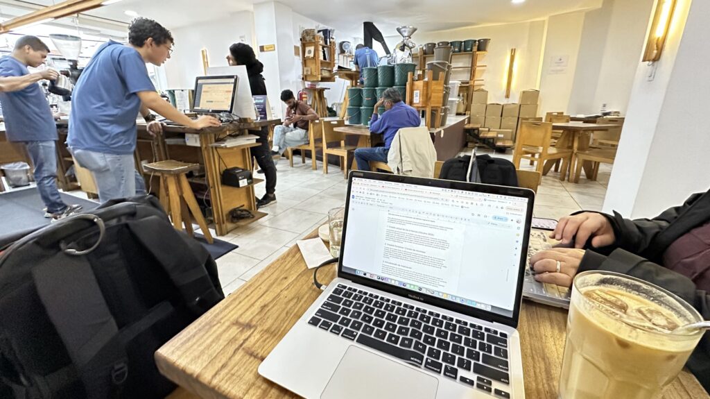 a laptop on a table at a cafe