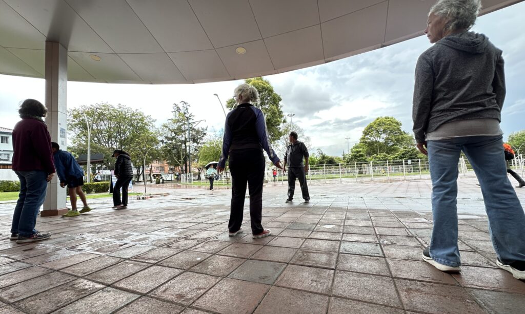 People practicing Taiji in a covered area