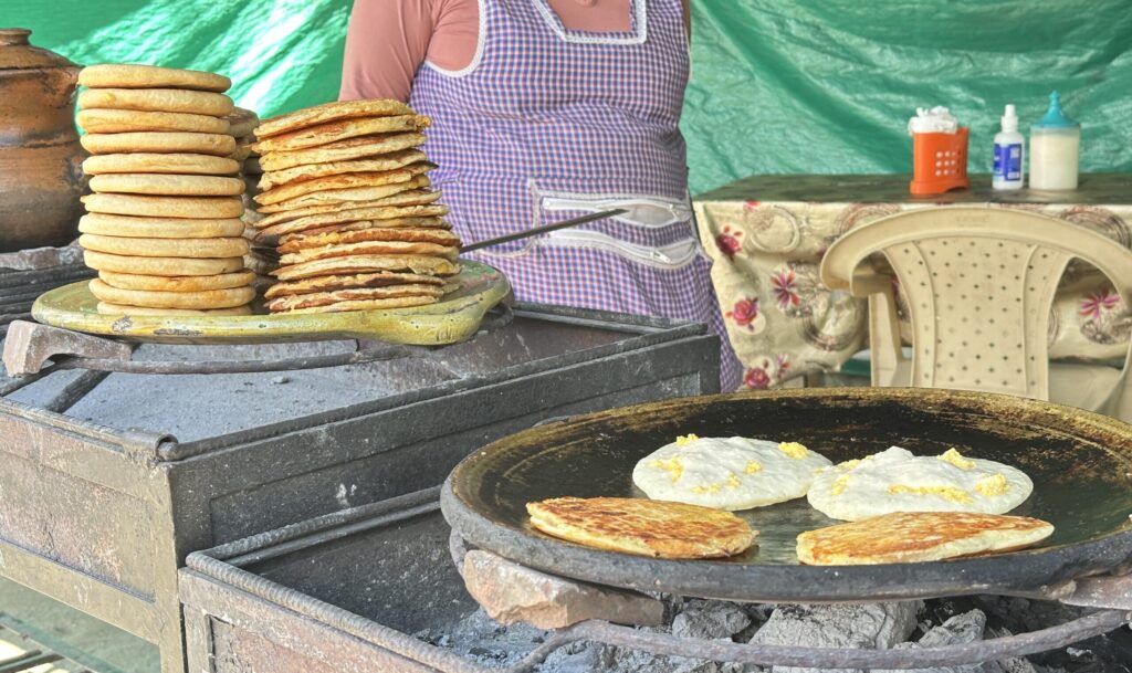 Tortillas stacked up and on a grill