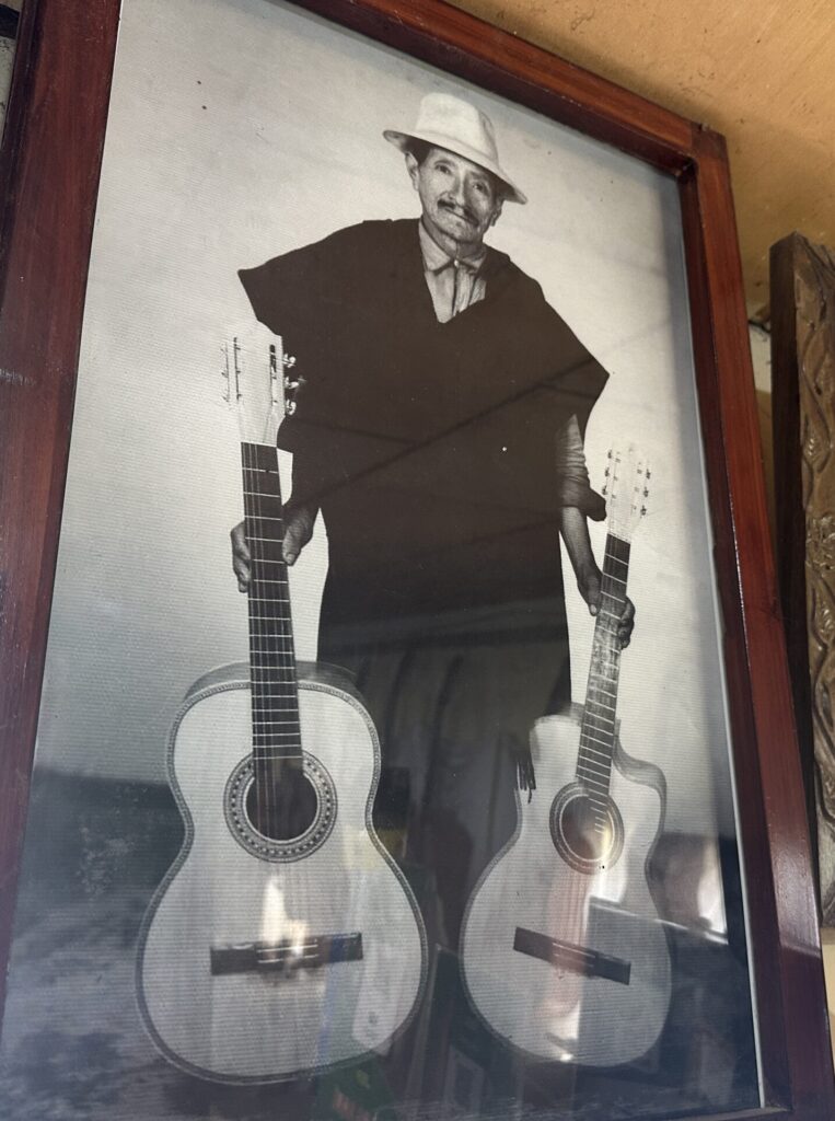 Another Mr. Uyaguari holding guitars