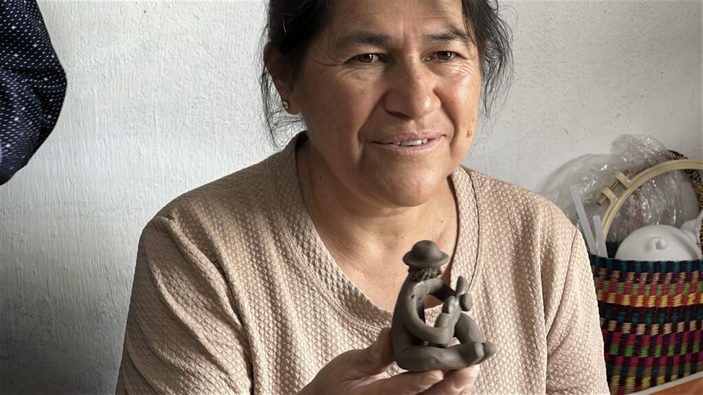 Clay artisan showing her work