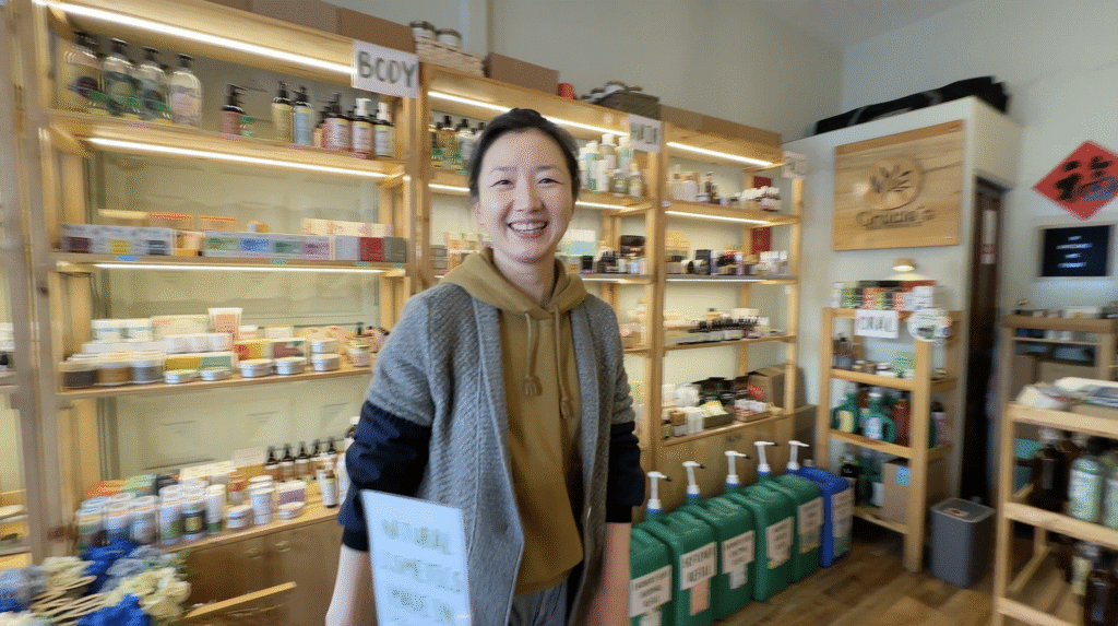 a woman smiling at the camera in a shop