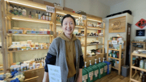 a woman smiling at the camera in a shop