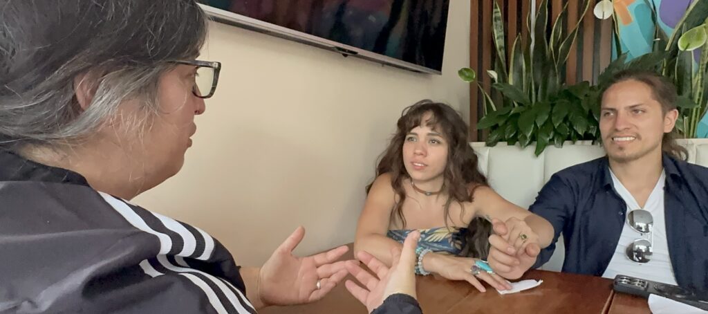 three people having a conversation at a table