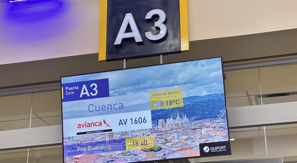 A gate sign at A3 in Quito stating a flight for Cuenca