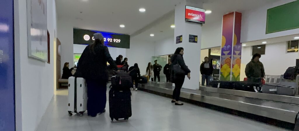 People at Cuenca Airport baggage claim