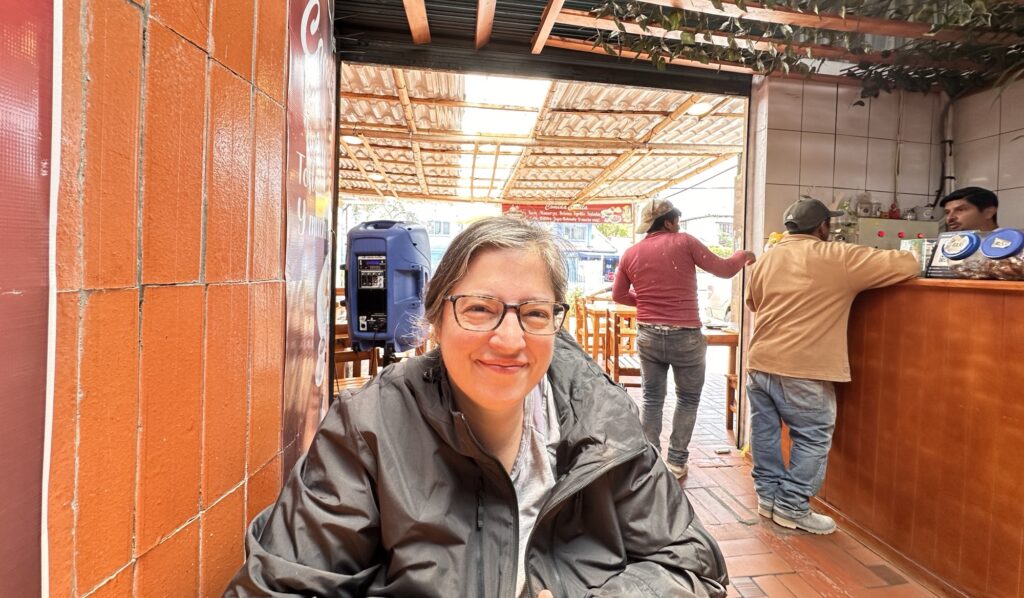 woman sitting at table in restaurant