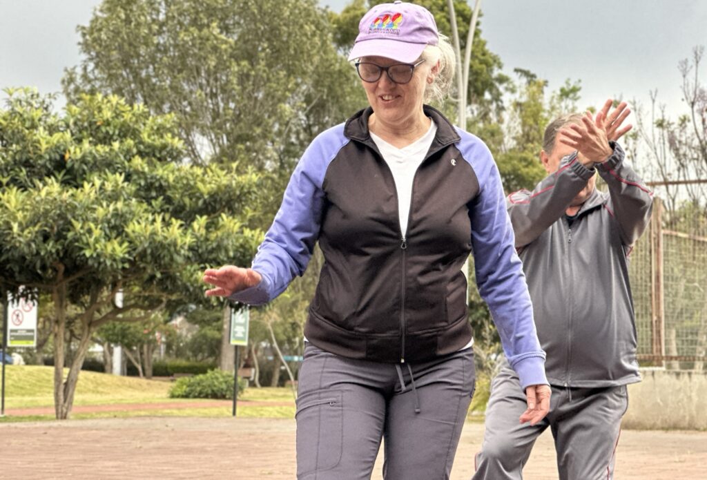 a woman and man practicing tai chi