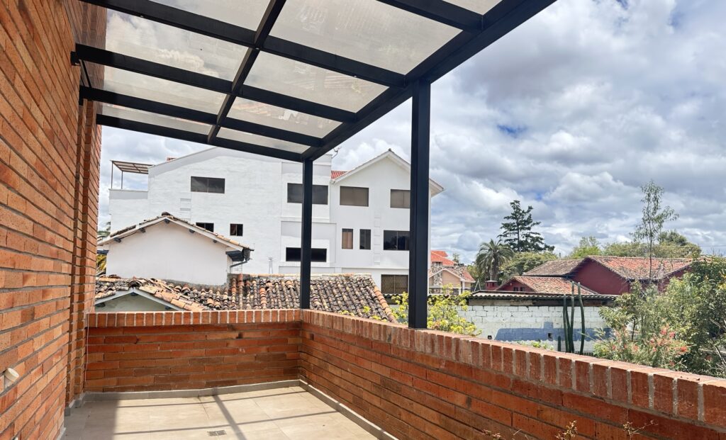 A patio looking out at buildings and the sky