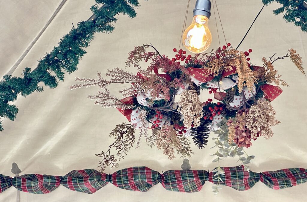 a christmas display hanging from a tent