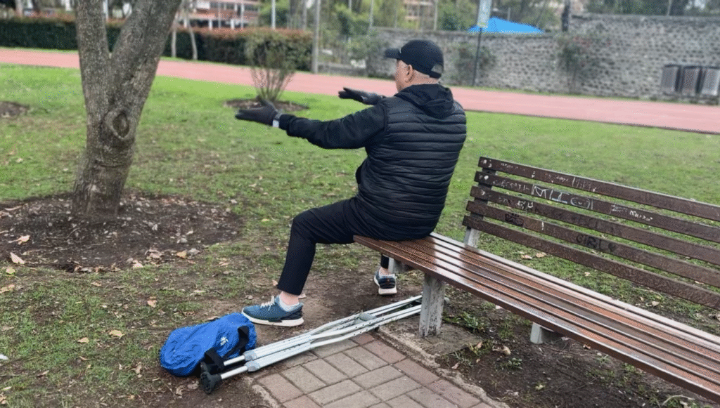 Man on bench doing tai chi