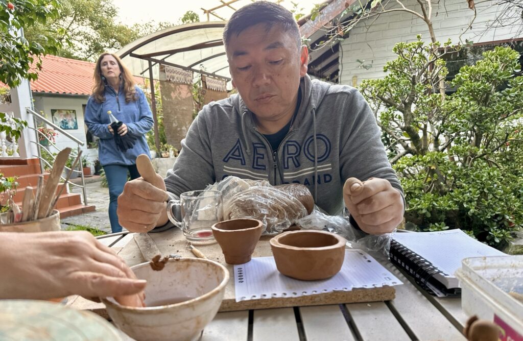 A man looking at ceramics