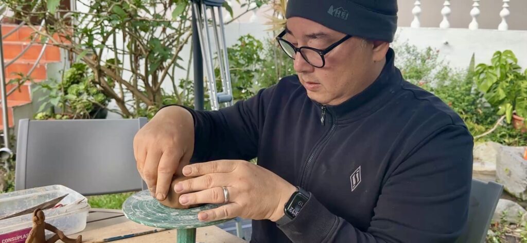 man making a ceramics bowl