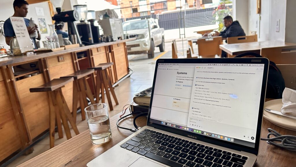 a laptop on a table in a coffee shop
