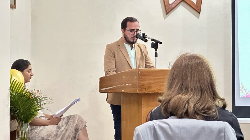 a man speaking at podium