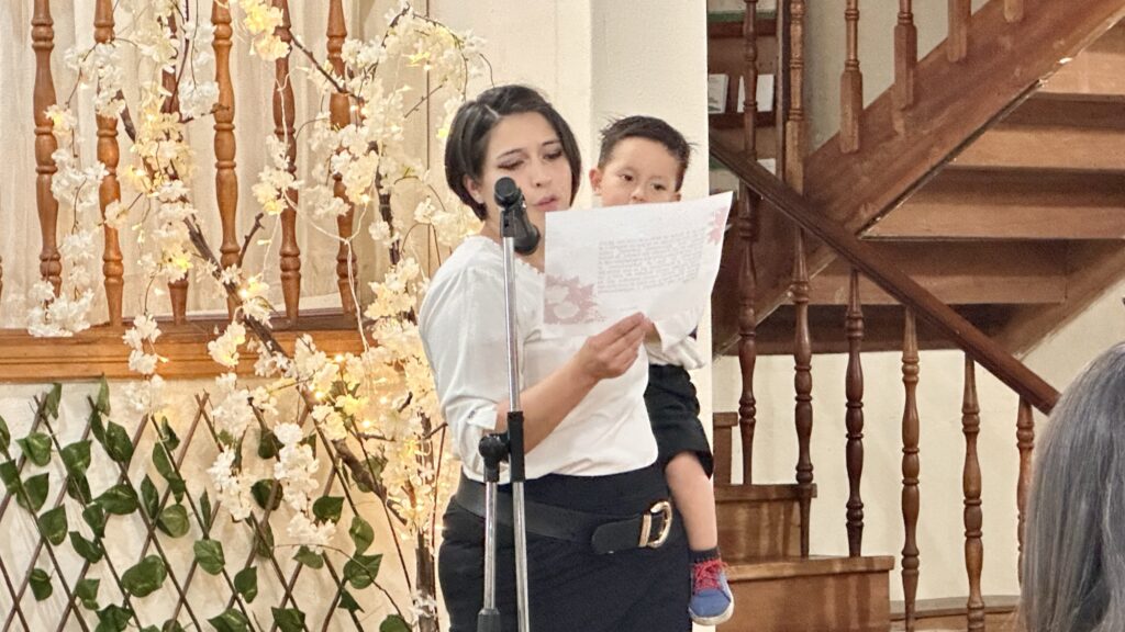 a woman holding a baby while reading