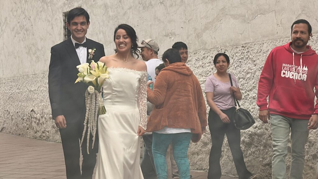 a couple in wedding outfits on the street