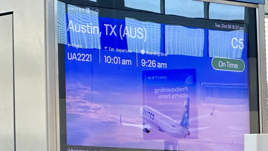 a gate sign for a flight to Austin