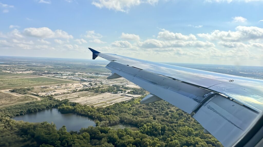 a plane landing over trees