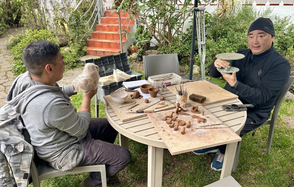 two men practicing ceramics