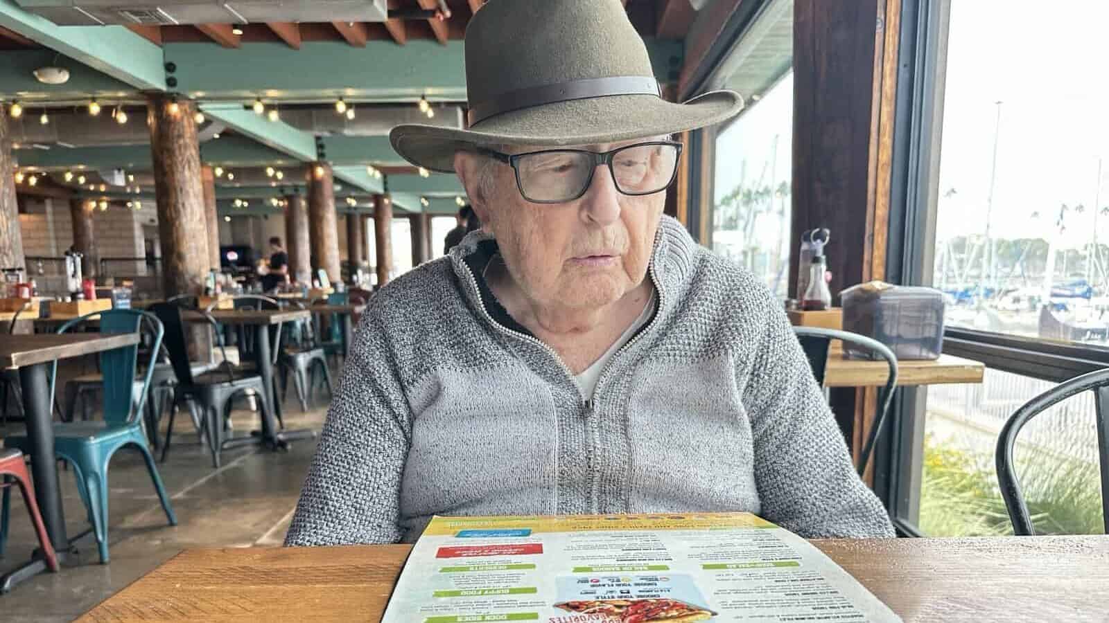 a man reading a menu in a restaurant