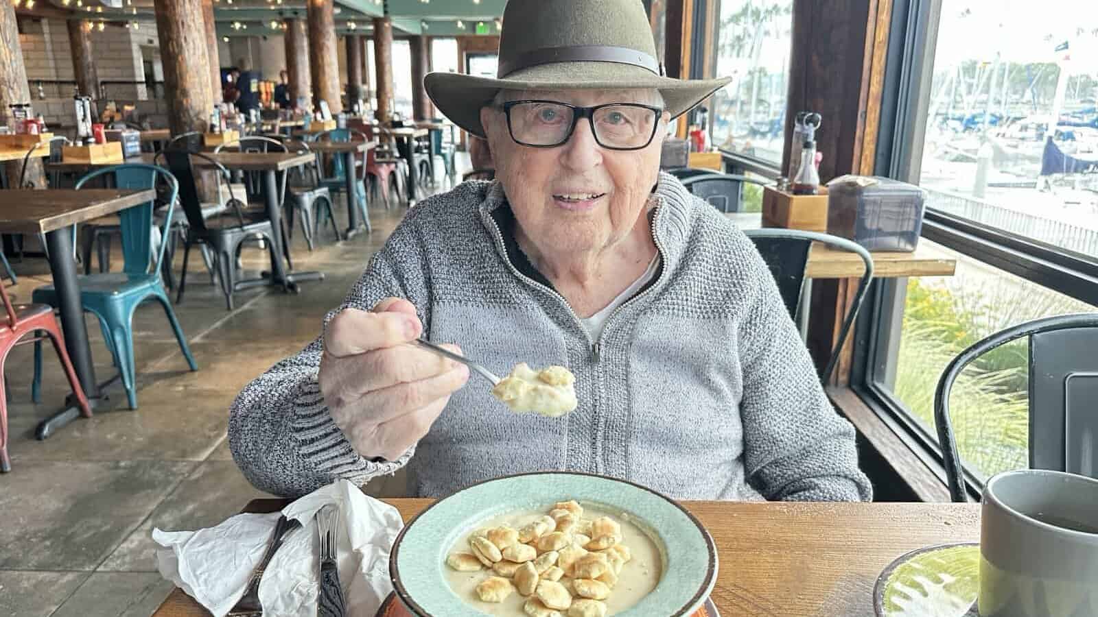 a man eating clam chowder