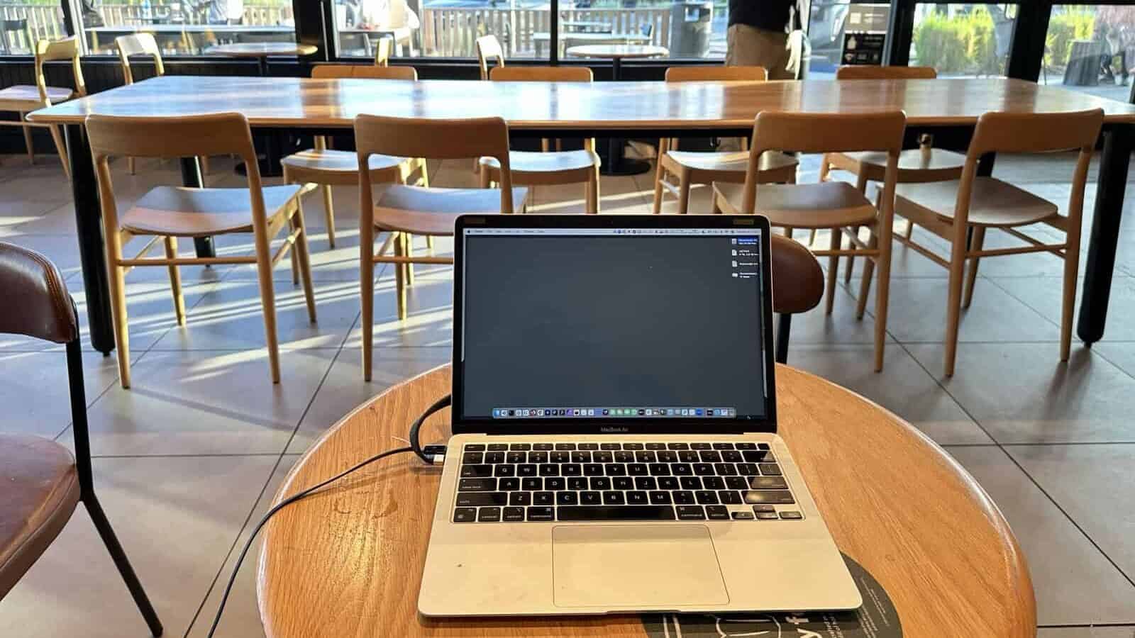 A computer on a table in a Starbucks